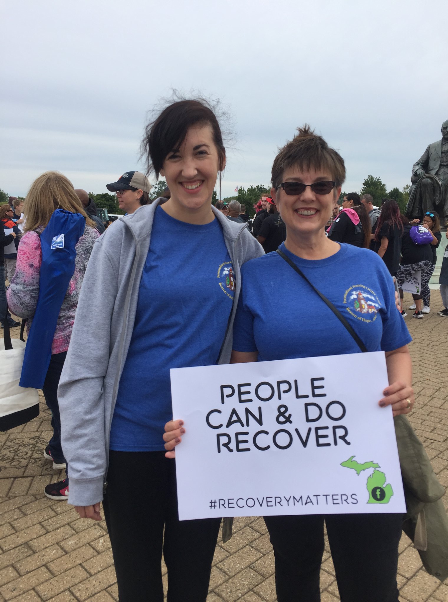Women Holding Recovery Sign